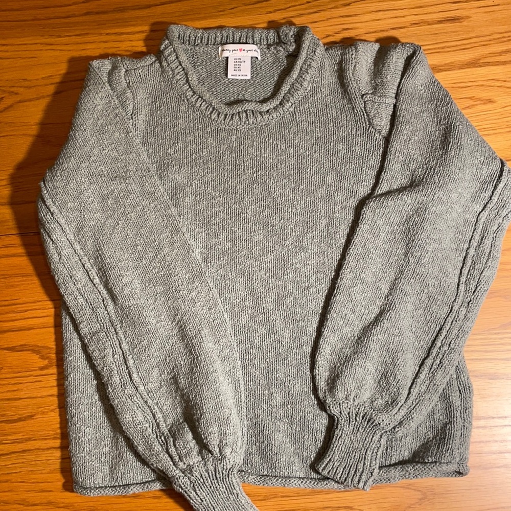 Blue-green sweater.